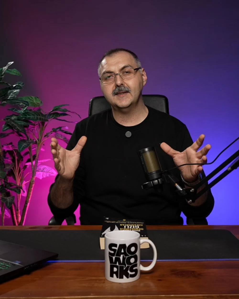 Fatih Bora speaking to camera at his studio desk during an online session.